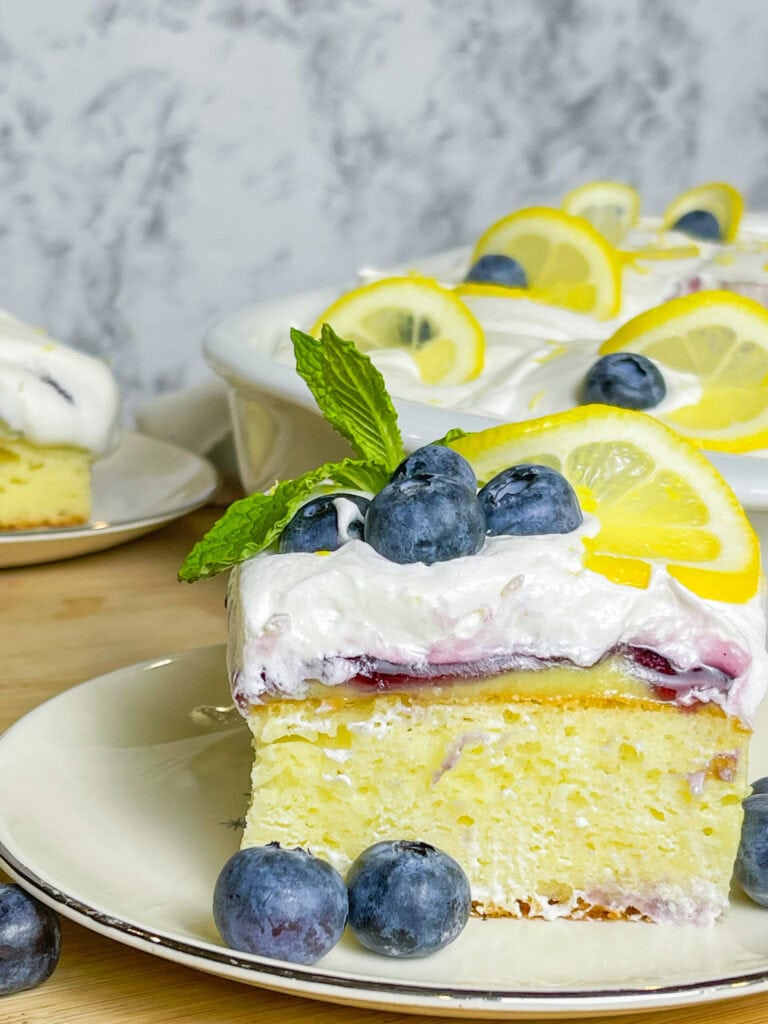 This Blueberry Lemon Poke Cake is a bright and refreshing dessert that’s as beautiful as it is delicious! It starts with a soft and fluffy white cake, infused with tangy lemon pudding that soaks into every bite, adding a burst of citrus flavor. A luscious layer of blueberry pie filling follows, bringing just the right balance of sweetness and fruitiness. Finally, it’s topped with a light and creamy whipped topping, making every forkful a dreamy combination of flavors and textures. Perfect for spring, summer, or anytime you’re craving a dessert that’s equal parts sweet, zesty, and irresistibly moist!