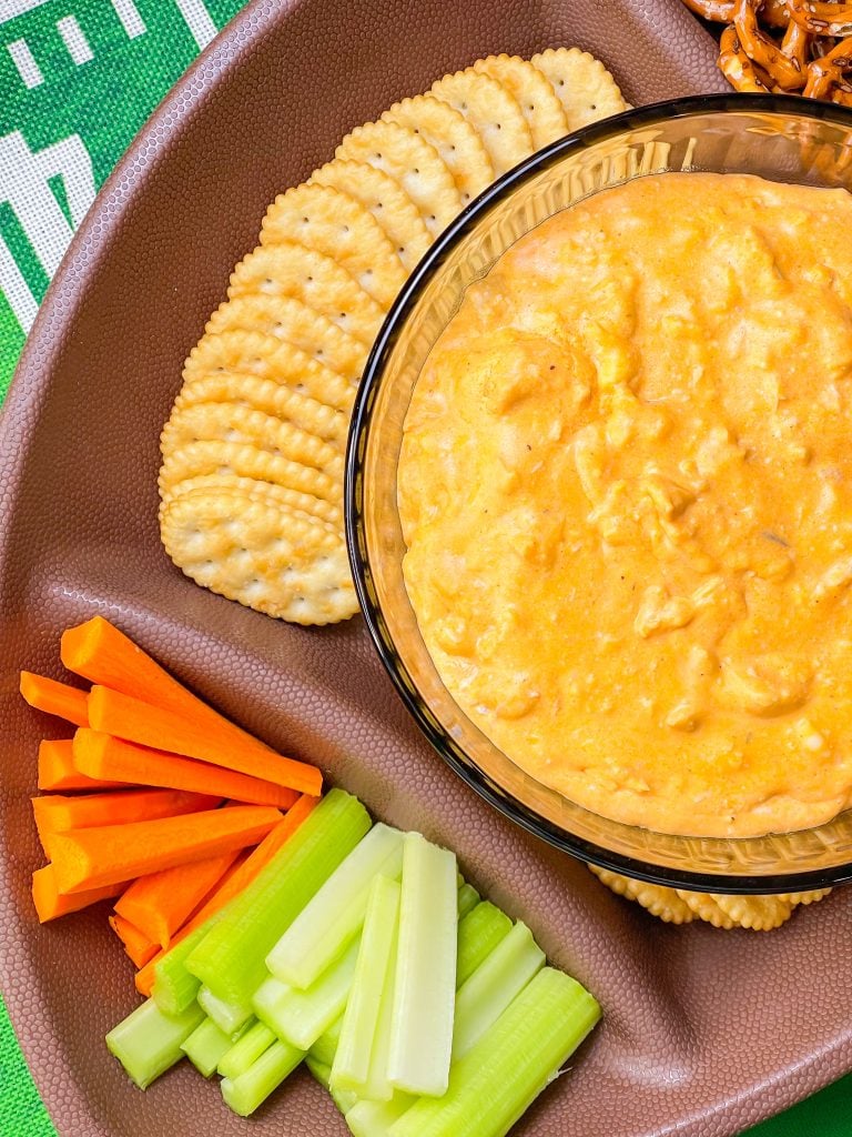 Crock Pot Buffalo Chicken Dip has all the flavors you love from buffalo wings but in a crowd friendly dip that's perfect to share for game day!