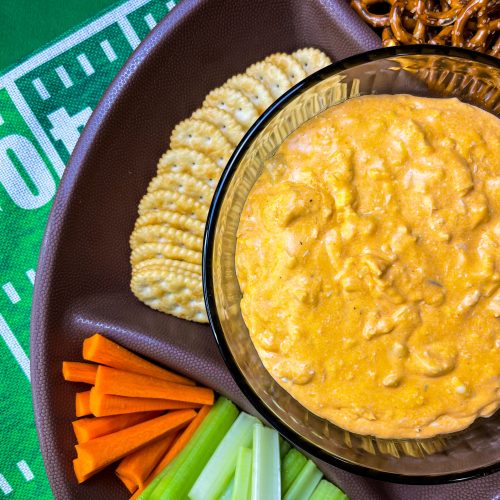 Crock Pot Buffalo Chicken Dip has all the flavors you love from buffalo wings but in a crowd friendly dip that's perfect to share for game day!