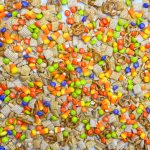 This sweet and salty Monster Mix is the perfect snack mix for the Halloween season. If you are a fan of a sweet and salty combo, then this snack mix is for you! It combines salty peanuts, pretzels and cereal with sweet M&Ms and candy corn in a brown sugar maple glaze. It's perfect for any Halloween or fall gathering.