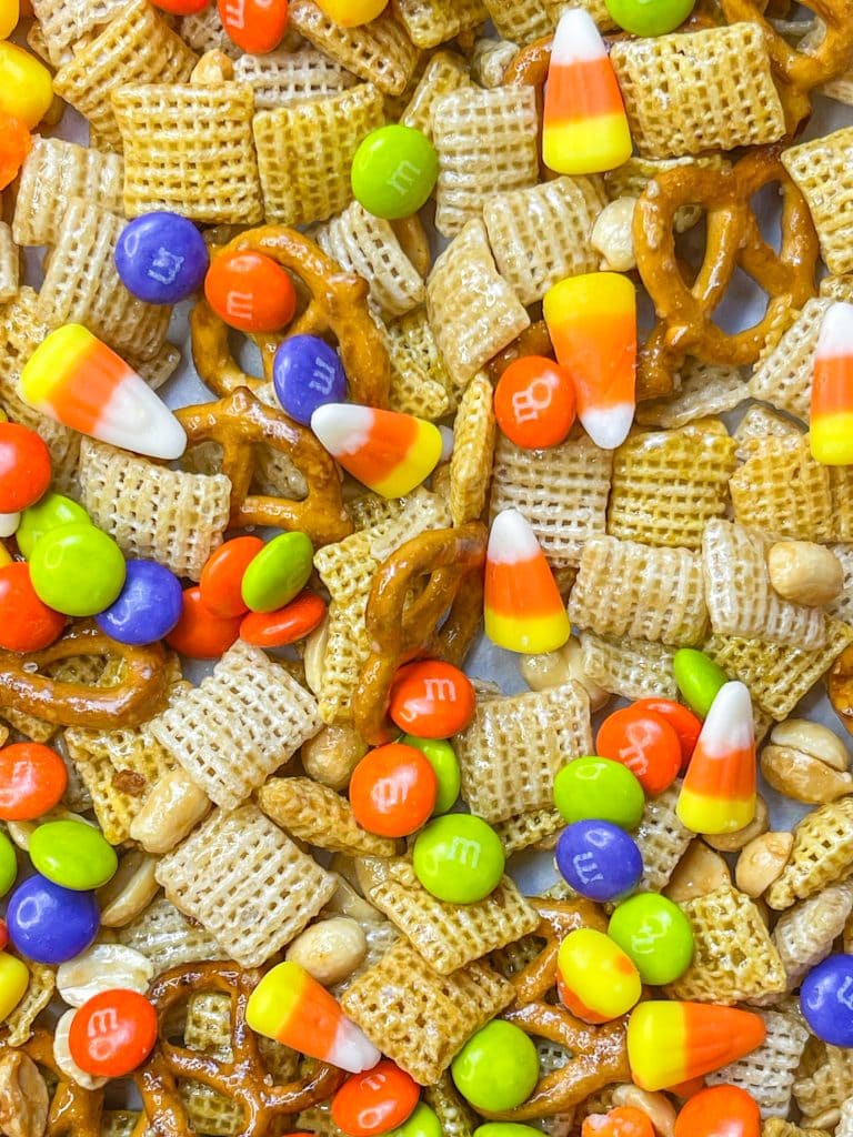 This sweet and salty Monster Mix  is the perfect snack mix for the Halloween season.

If you are a fan of a sweet and salty combo, then this snack mix is for you! It combines salty peanuts, pretzels and cereal with sweet M&Ms and candy corn in a brown sugar maple glaze. It's perfect for any Halloween or fall gathering.