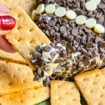 Football Cheesecake Dip is a chocolate chip cheesecake type dip served with graham crackers for dipping. It's a fun and sweet addition to any tailgate table.