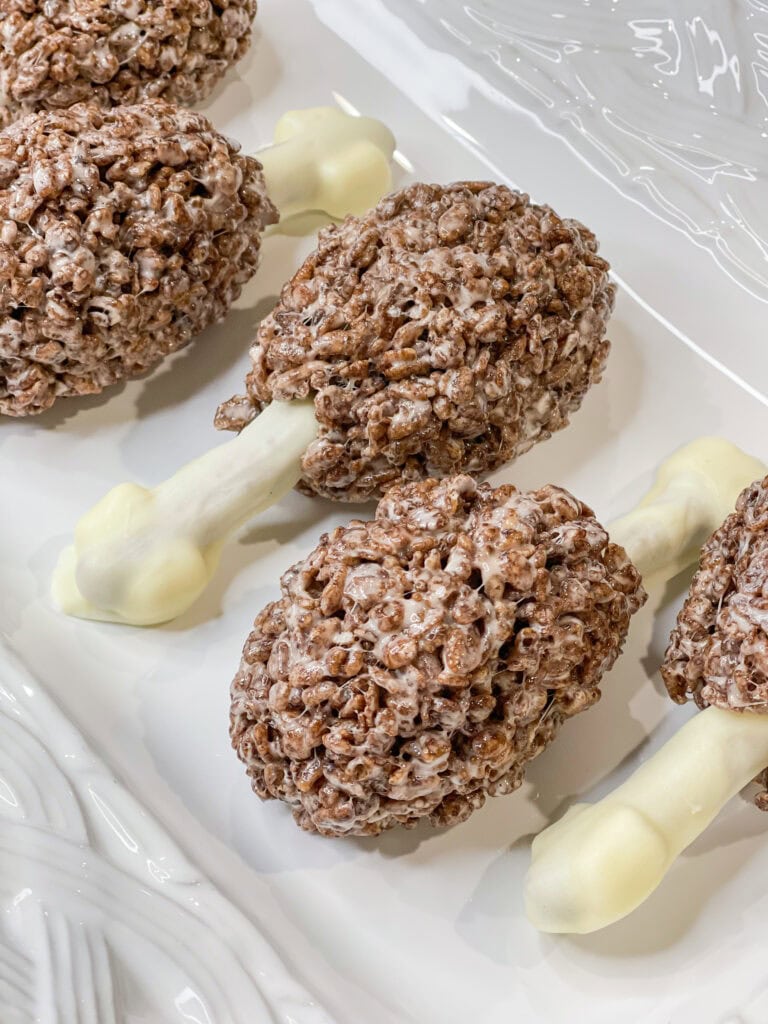 Rice Krispie Treat Turkey Legs are so much fun for Thanksgiving! They are made with chocolate Rice Krispies, white chocolate, mini marshmallows, and pretzel sticks. The drumsticks look like turkey legs but taste just like the Rice Krispie Treats you love. 