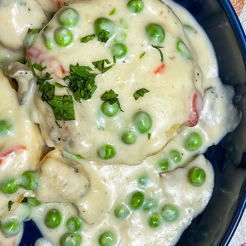 Juicy chicken breast in a creamy mushroom sauce with peas and pimentos, spooned over buttery biscuits; Chicken a La King is the ultimate comfort meal.