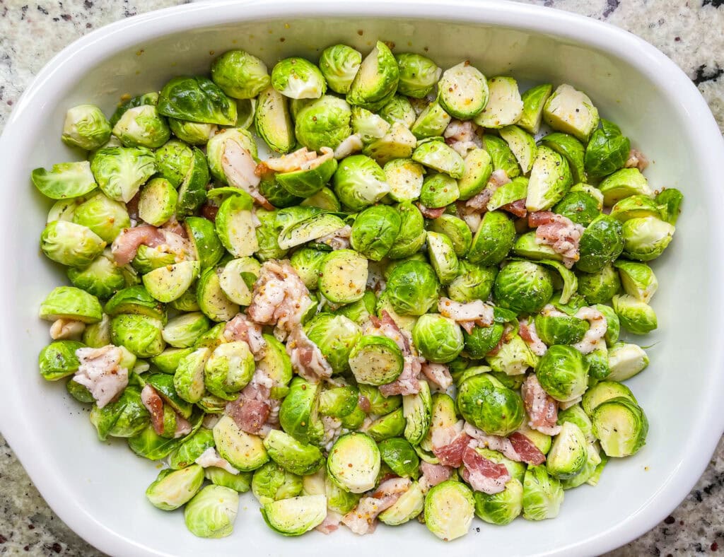 Brusselsprouts Au Gratin is brusselsprouts roasted with bacon in a maple mustard sauce and topped with a cheesy gruyere sauce. It's the perfect side dish for Thanksgiving, a holiday dinner, or any day of the week!