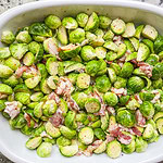 Brusselsprouts Au Gratin is brusselsprouts roasted with bacon in a maple mustard sauce and topped with a cheesy gruyere sauce. It's the perfect side dish for Thanksgiving, a holiday dinner, or any day of the week!