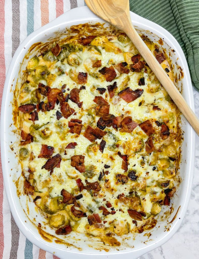 Brusselsprouts Au Gratin is brusselsprouts roasted with bacon in a maple mustard sauce and topped with a cheesy gruyere sauce. It's the perfect side dish for Thanksgiving, a holiday dinner, or any day of the week!