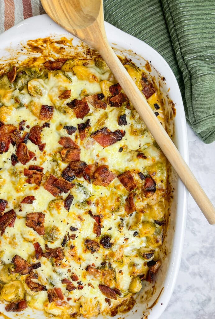 Brusselsprouts Au Gratin is brusselsprouts roasted with bacon in a maple mustard sauce and topped with a cheesy gruyere sauce. It's the perfect side dish for Thanksgiving, a holiday dinner, or any day of the week!