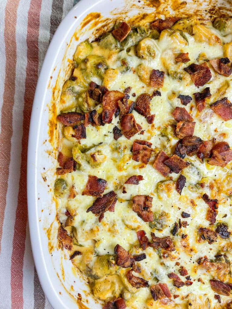 Brusselsprouts Au Gratin is brusselsprouts roasted with bacon in a maple mustard sauce and topped with a cheesy gruyere sauce. It's the perfect side dish for Thanksgiving, a holiday dinner, or any day of the week!