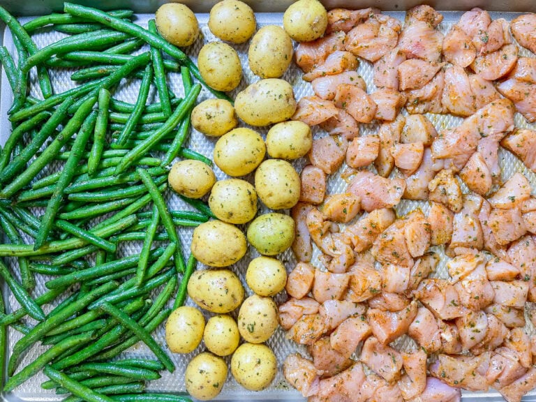 This easy Sheet Pan Ranch Chicken dinner is a weeknight lifesaver! Juicy chicken, tender baby potatoes, and crisp-tender green beans are tossed in flavorful ranch seasoning and roasted together on one pan.