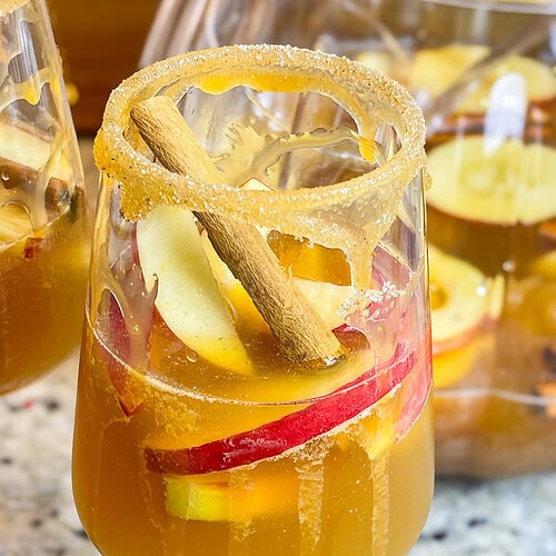 A refreshing autumn cocktail, Sparkling Apple Cider Sangria is made with simple ingredients-prosecco, apple cider, amaretto and club soda. It's a perfect pitcher drink for any occasion.