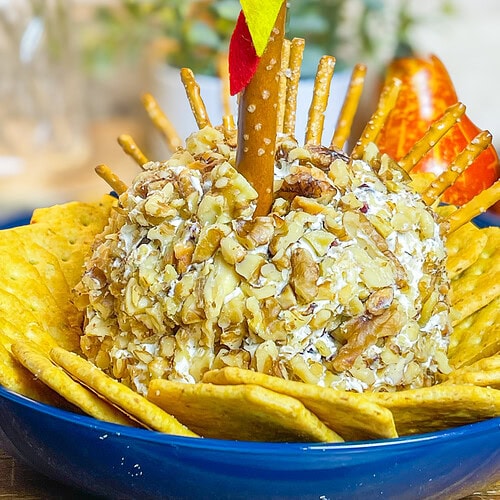 Looking for a crowd-pleasing, festive appetizer for your Thanksgiving table? This adorable Turkey Cheese Ball is not only fun to make but also incredibly delicious. With creamy, tangy layers of cream cheese and white cheddar mixed with savory herbs, walnuts, and a hint of sweet craisins, it’s packed with flavor in every bite. Shaped like a turkey and decorated with a pretzel rod "neck" and candy eyes, this appetizer is sure to be the star of your spread. Paired with pretzel sticks and crackers, it’s the perfect appetizer to kick off your Thanksgiving feast, delighting guests of all ages.