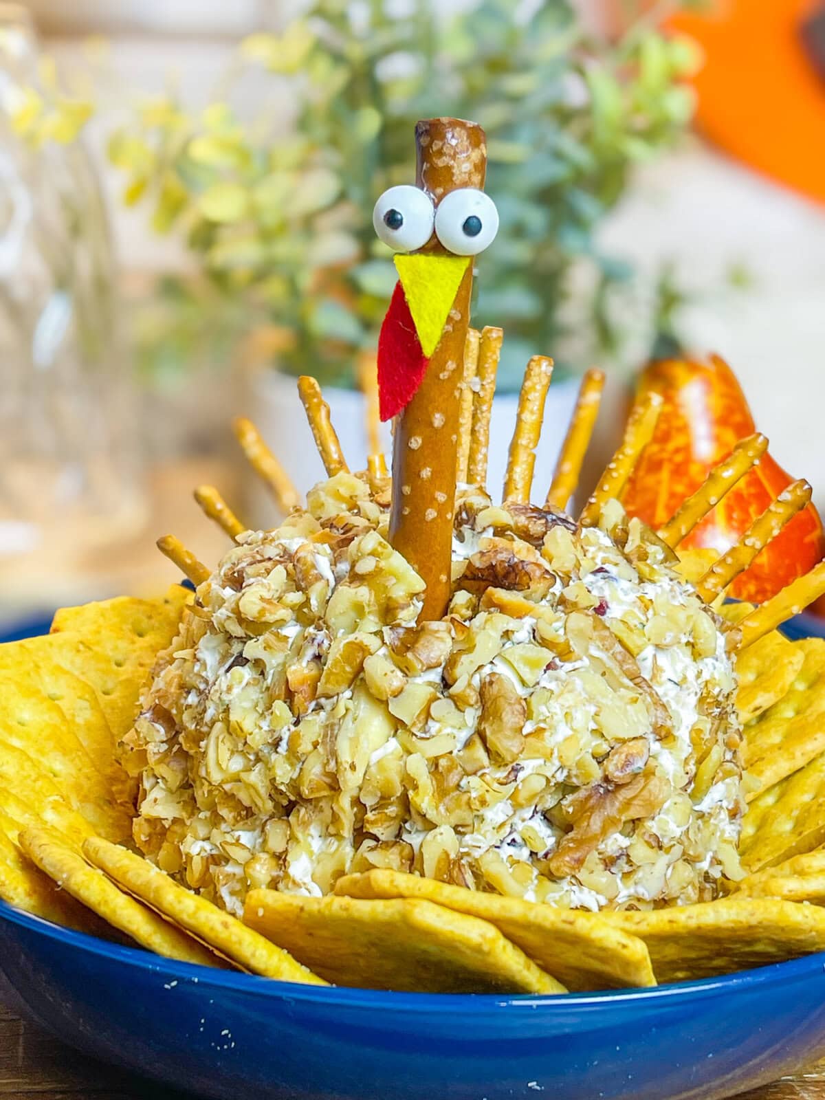 Looking for a crowd-pleasing, festive appetizer for your Thanksgiving table? This adorable Turkey Cheese Ball is not only fun to make but also incredibly delicious. With creamy, tangy layers of cream cheese and white cheddar mixed with savory herbs, walnuts, and a hint of sweet craisins, it’s packed with flavor in every bite. Shaped like a turkey and decorated with a pretzel rod "neck" and candy eyes, this appetizer is sure to be the star of your spread. Paired with pretzel sticks and crackers, it’s the perfect appetizer to kick off your Thanksgiving feast, delighting guests of all ages.