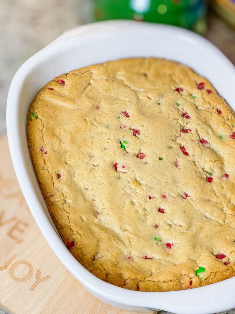 M&M Christmas Cookie Bars are the ultimate holiday treat, combining all the festive fun of Christmas cookies with the ease of a one-pan dessert. These bars are soft, chewy, and bursting with colorful red and green M&M candies. These cookie bars are made with a buttery, golden cookie base and plenty of chocolatey M&M's, these bars are perfect for holiday parties, cookie exchanges, or a cozy night at home with a cup of hot cocoa. Whether you’re baking with kids or whipping up a quick treat for a crowd, these cookie bars are a festive, fuss-free way to spread holiday cheer!