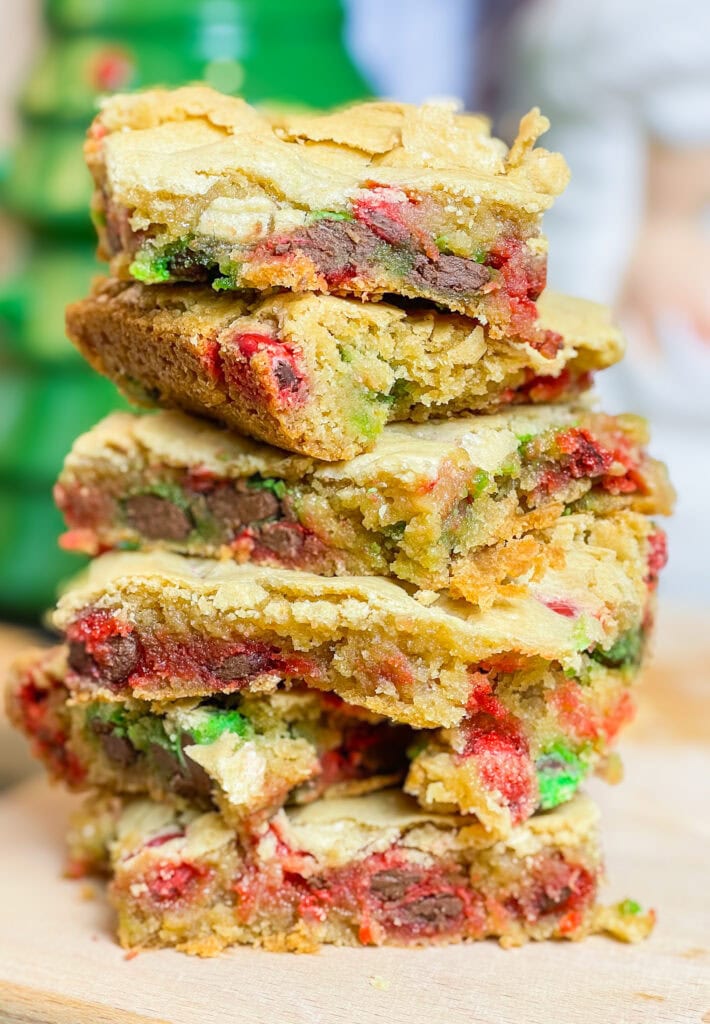 M&M Christmas Cookie Bars are the ultimate holiday treat, combining all the festive fun of Christmas cookies with the ease of a one-pan dessert. These bars are soft, chewy, and bursting with colorful red and green M&M candies. These cookie bars are made with a buttery, golden cookie base and plenty of chocolatey M&M's, these bars are perfect for holiday parties, cookie exchanges, or a cozy night at home with a cup of hot cocoa. Whether you’re baking with kids or whipping up a quick treat for a crowd, these cookie bars are a festive, fuss-free way to spread holiday cheer!