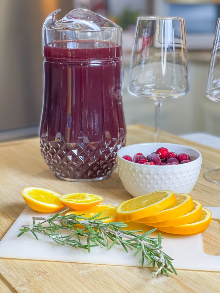 Christmas Sangria is a festive and flavorful holiday cocktail that’s perfect for sharing! Made in a pitcher for easy serving, it combines the rich warmth of red wine with the nutty sweetness of amaretto and the deep fruitiness of blackberry brandy. Orange juice and cranberry juice add a bright, tangy twist, creating a balanced and refreshing drink that’s as vibrant as the season itself. Garnished with fresh cranberries, orange slices, and sprigs of rosemary, this sangria looks as beautiful as it tastes. It’s the ultimate crowd-pleaser for Christmas parties and cozy holiday gatherings!