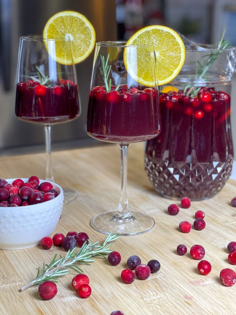 Christmas Sangria is a festive and flavorful holiday cocktail that’s perfect for sharing! Made in a pitcher for easy serving, it combines the rich warmth of red wine with the nutty sweetness of amaretto and the deep fruitiness of blackberry brandy. Orange juice and cranberry juice add a bright, tangy twist, creating a balanced and refreshing drink that’s as vibrant as the season itself. Garnished with fresh cranberries, orange slices, and sprigs of rosemary, this sangria looks as beautiful as it tastes. It’s the ultimate crowd-pleaser for Christmas parties and cozy holiday gatherings! 