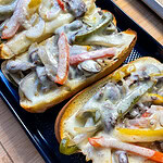 These easy Sheet Pan Cheesesteak Sandwiches are ready in under 30 minutes! A soft bun loaded with marinated beef, bright bell peppers, onions and earthy mushrooms, covered in melty cheese for a flavor packed family dinner.