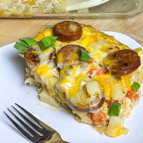 This Andouille Sausage Breakfast Casserole is flavor packed with savory smoked andouille sausage, tender hashbrown potatoes, fluffy eggs, vibrant bell peppers, and gooey melted cheese. Baked to golden perfection, this casserole is the ultimate crowd-pleaser for brunches and holiday mornings!