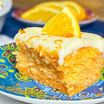 Orange Creamsicle Poke Cake tastes just like the ice cream treat you remember- a bright orange tang along with a creamy vanilla finish. This cake starts with an orange boxed cake mix, studded with creamy orange Jell-o and finished with a citrus orange cream cheese frosting. You'll want to start bringing this dessert everywhere!