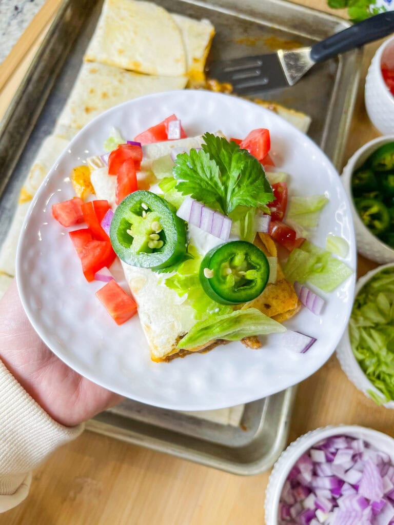 Sheet Pan Quesadillas are easy, kid friendly, quick, and they feed a crowd! Keeping the filling simple allows everyone to customize their favorite toppings.